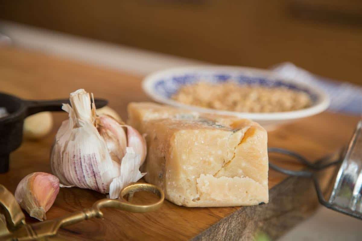 parmesan cheese and garlic bulb on table