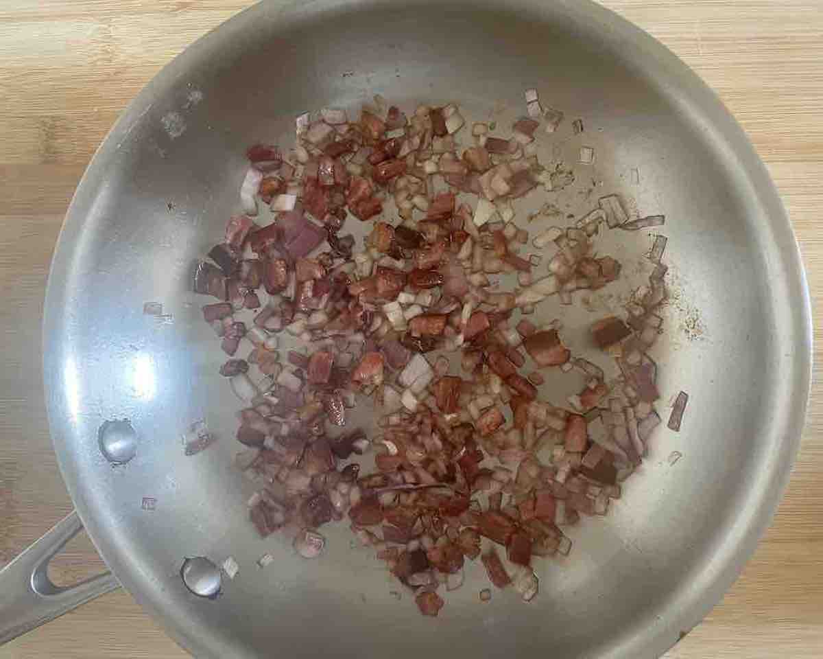 bacn and onions cooking in a pan
