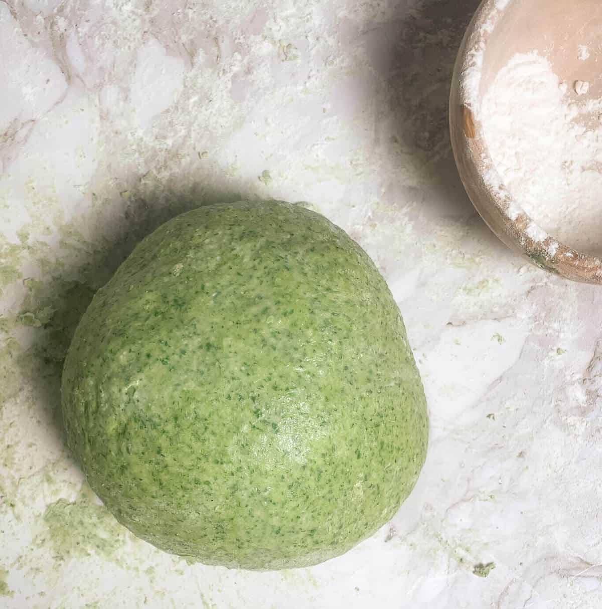 ball of green pasta dough