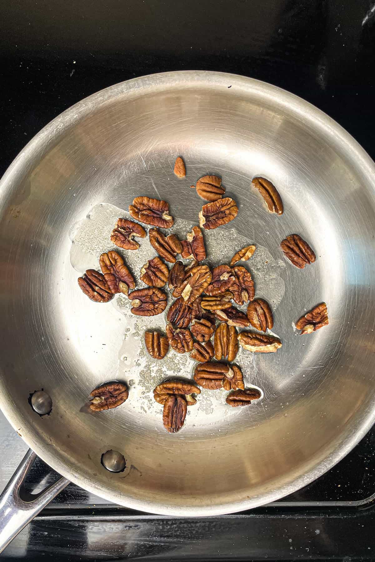 pecans toasting in a pan