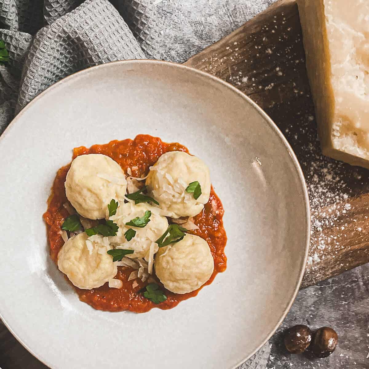 gnudi in a bowl with tomato sauce