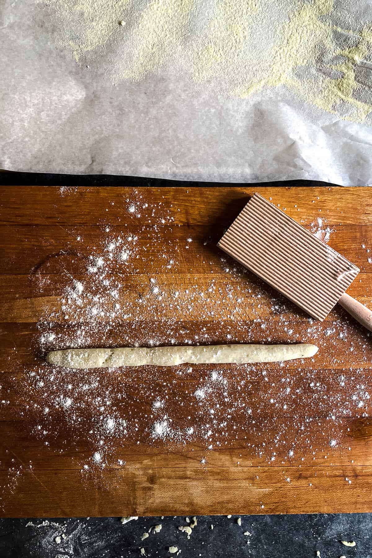 roll of gnocchi dough on a cutting board
