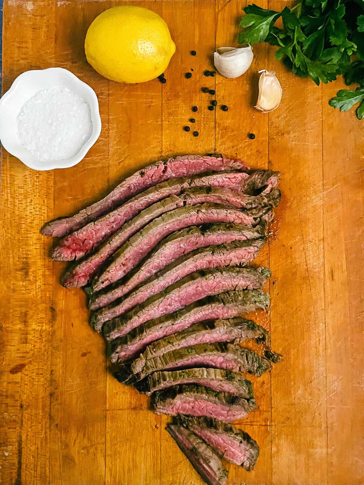 pieces of flank steak on a cutting board