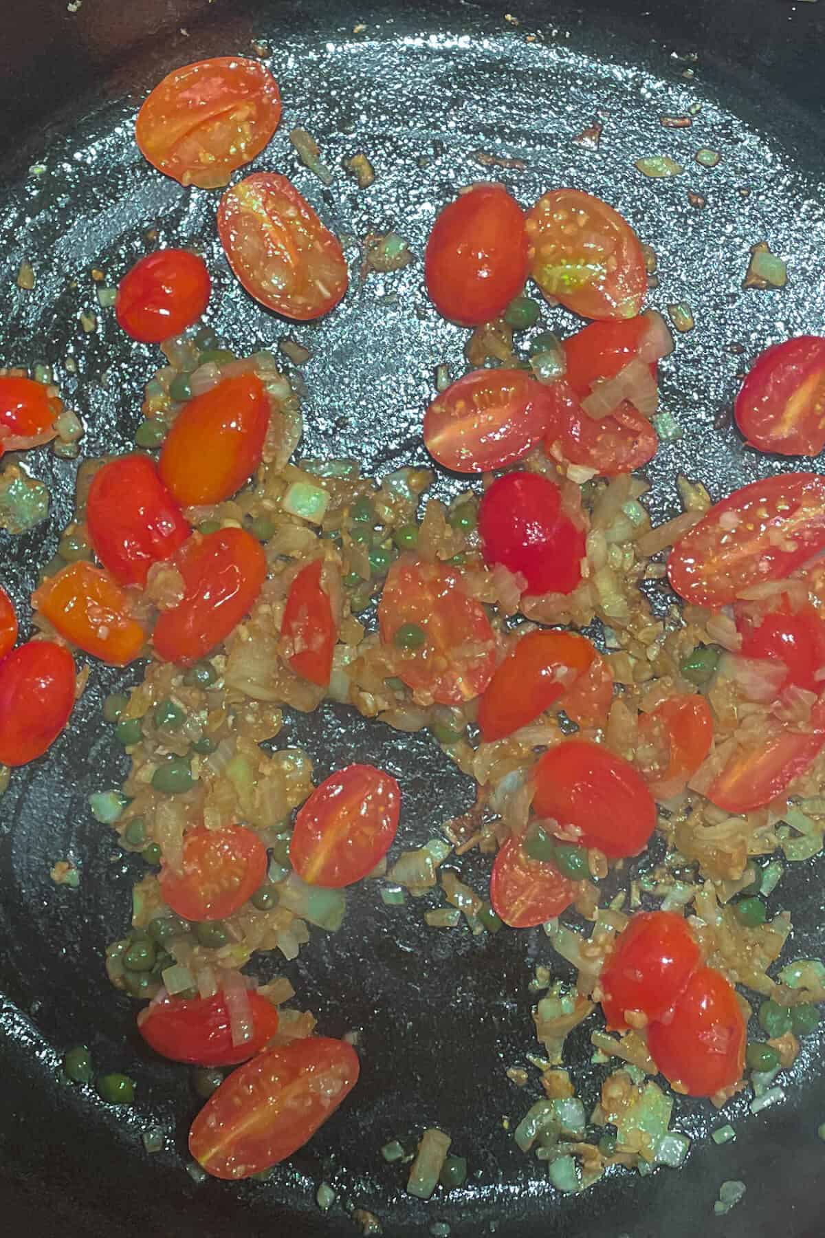 tomatoes, onions and capers in a pan